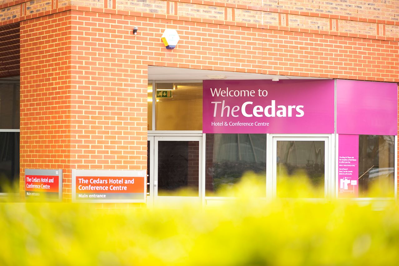 An exterior photo of Cedars Hotel building and signage