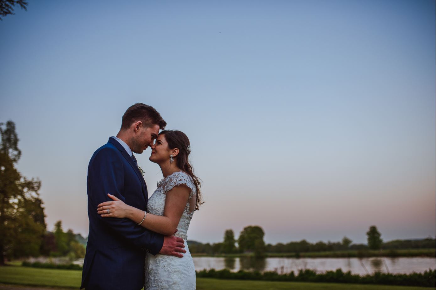 A photo of a wedding couple at Henley Greenlands with the River Thames in the background