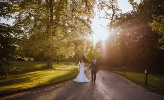 A wedding photo of a couple walking along the main pathway