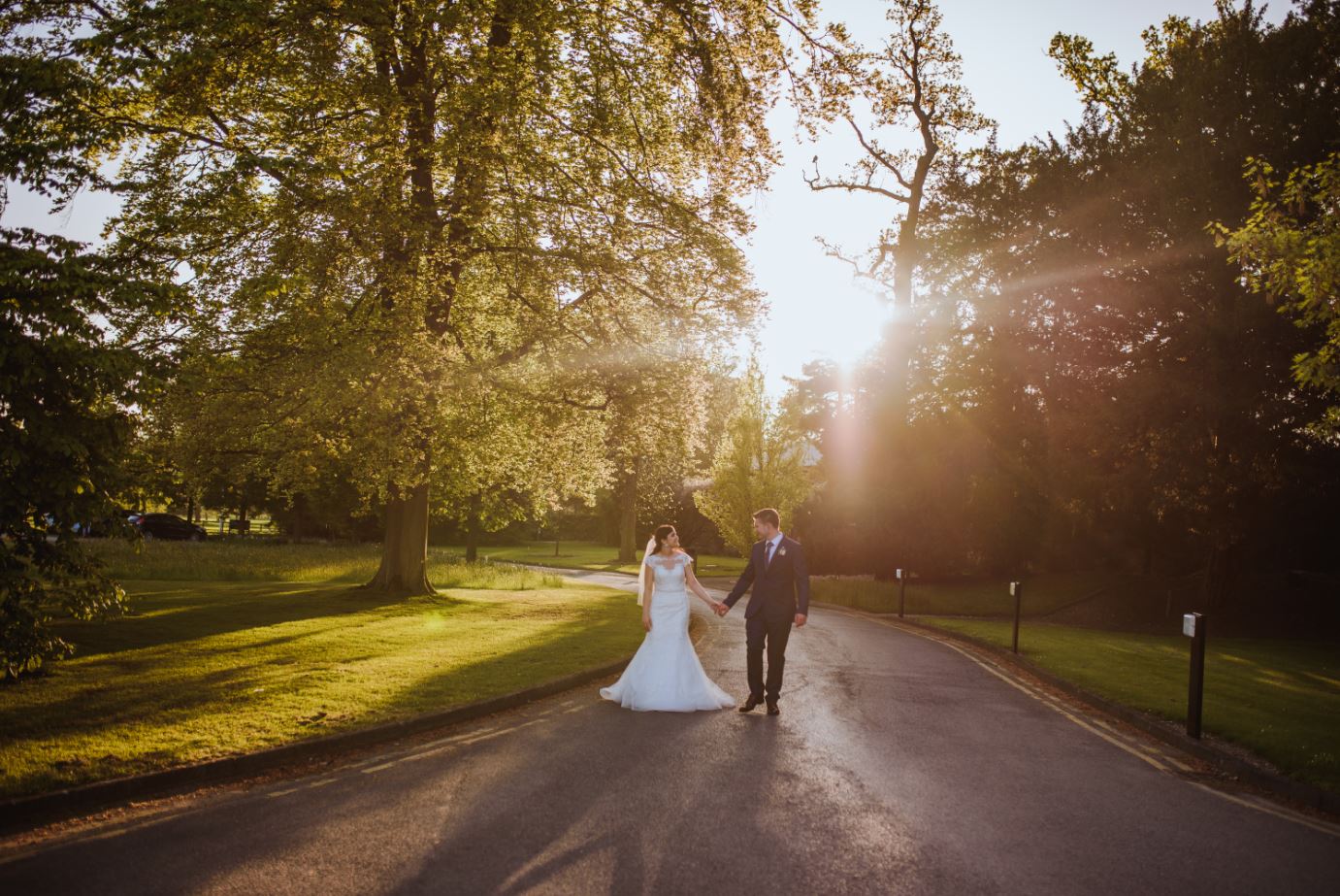 A wedding photo of a couple walking along the main pathway